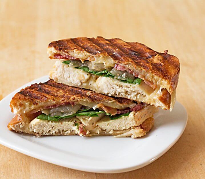 Two panini halves stacked on a plate