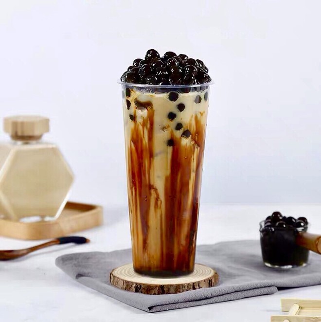 Brown Sugar Boba Drink on a wood coaster